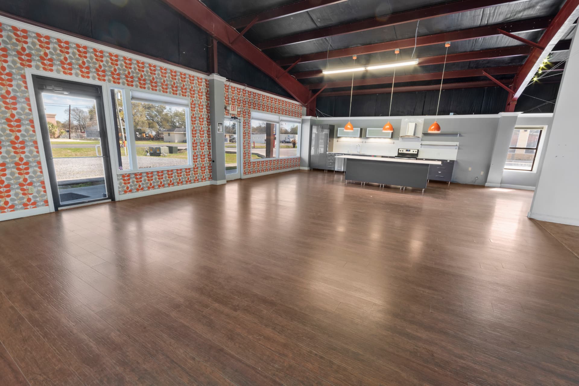 Spacious commercial kitchen and open showroom area with vaulted ceilings